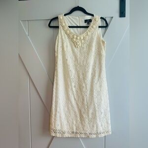 Ivory dress with lace overlay/ accents at neckline. Size 8. Excellent condition.